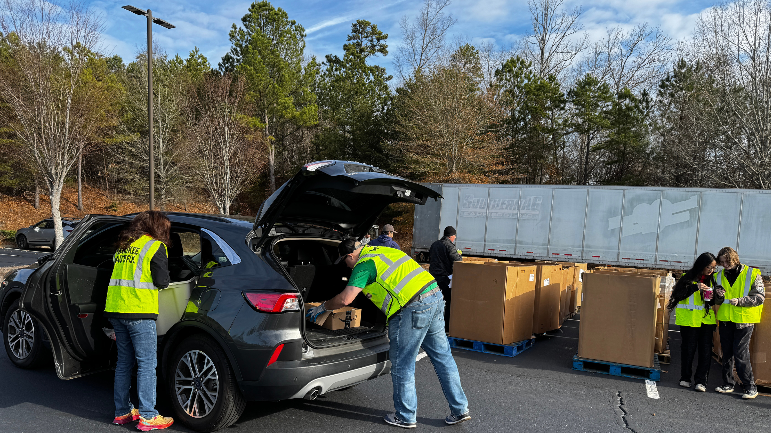 Volunteer unloading donated items into bins 